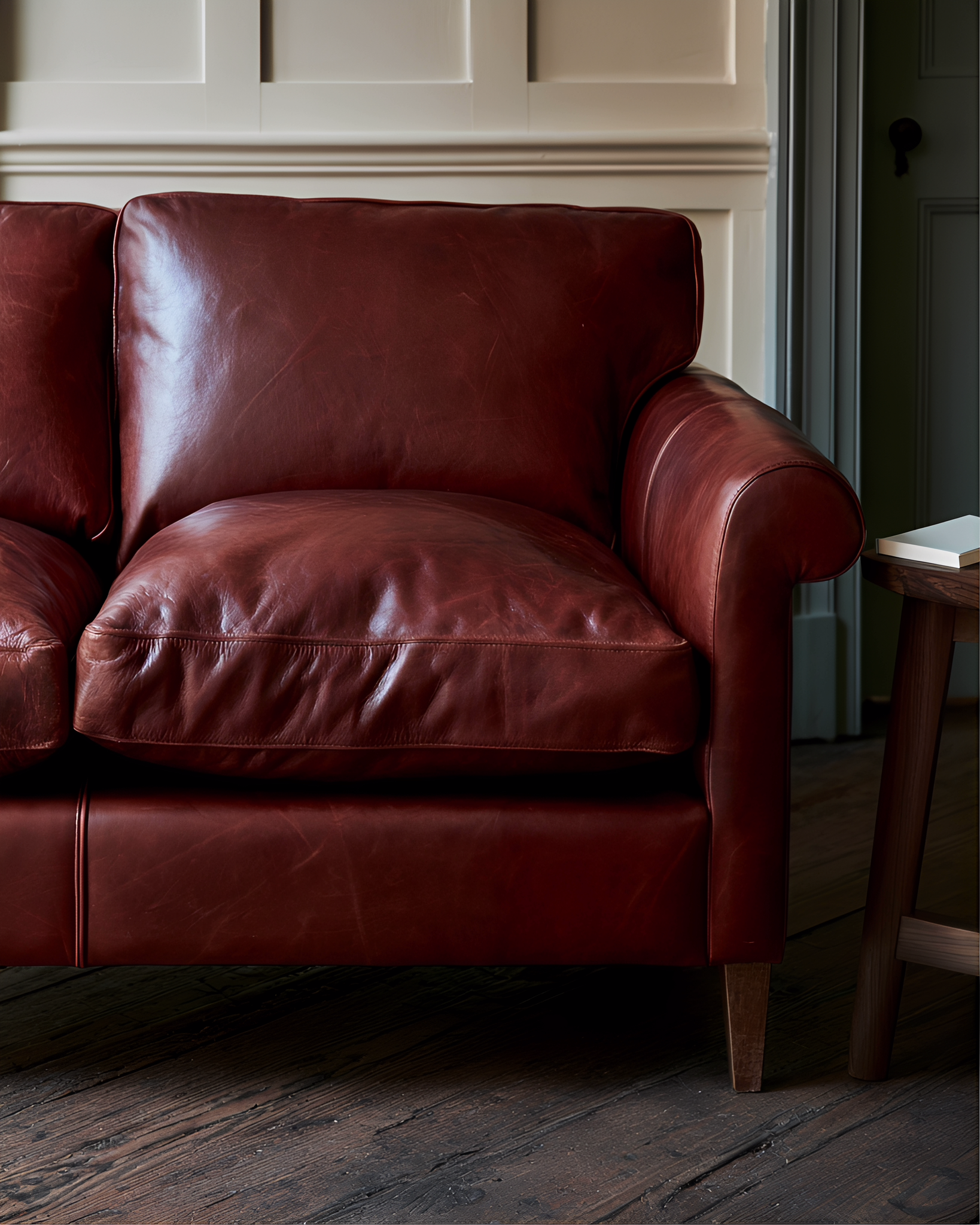 Detail of a wine-red leather seat in soft side light